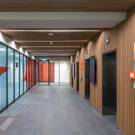 Floor level number and wayfinding sign at wall