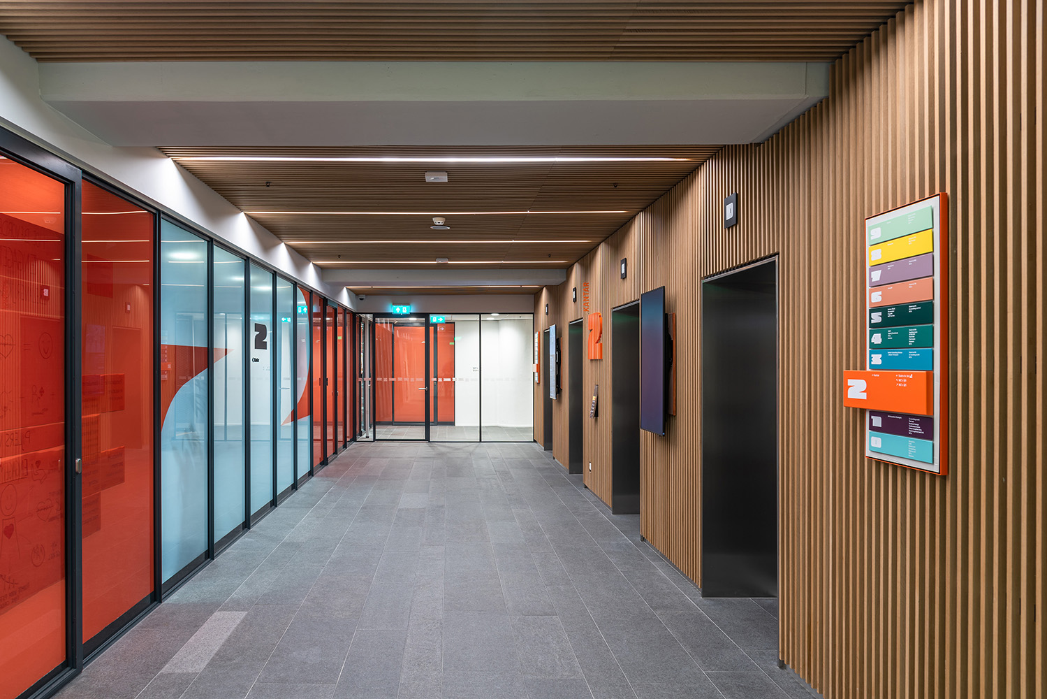 Floor level number and wayfinding sign at wall